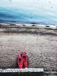 High angle view of red shoes on beach