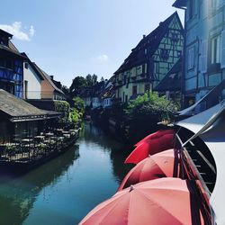 Canal amidst buildings against sky