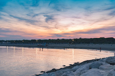 Scenic view of lake against sky during sunset