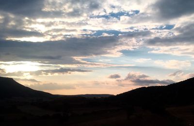 Scenic view of mountains against cloudy sky