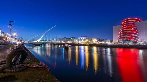 View of bridge over river at night