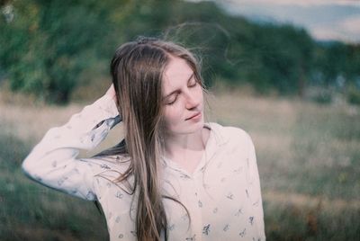 Portrait of a beautiful young woman on field