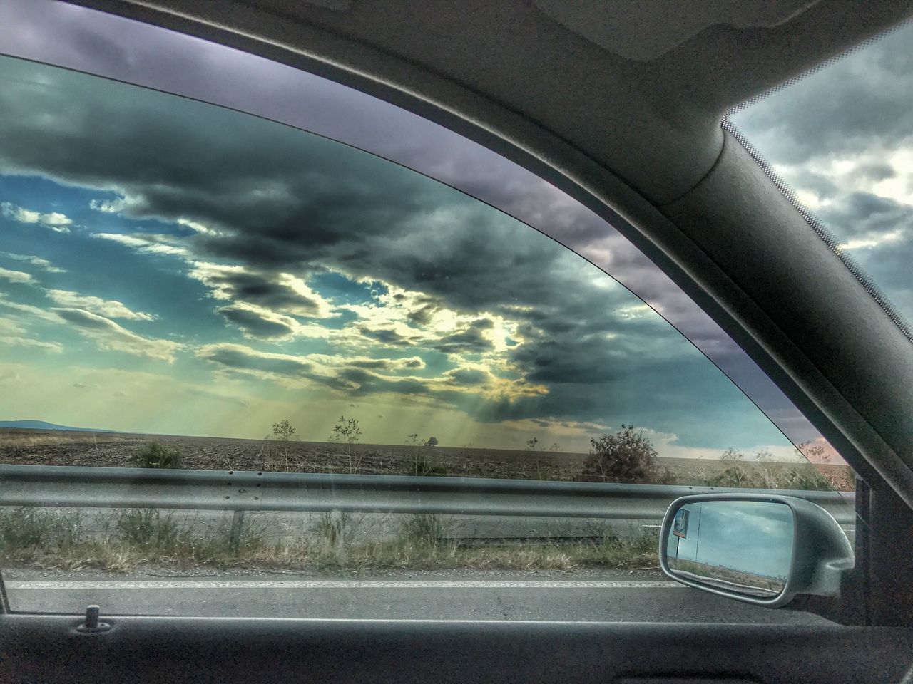 VIEW OF ROAD THROUGH CAR WINDOW