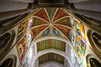 Low angle view of colorful mural ceiling at royal cathedral