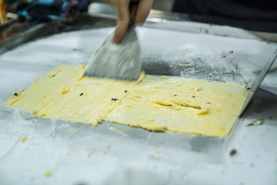 Cropped image of person preparing food in restaurant