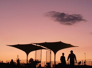 Silhouette people against clear sky during sunset