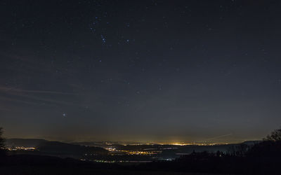 Aerial view of city against sky at night