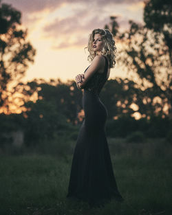 Side view of woman standing on field