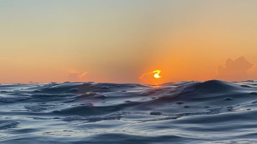 Scenic view of sea against clear sky during sunset
