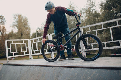 Man with bicycle at park