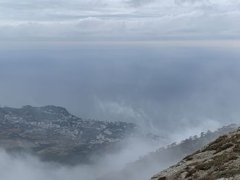 Scenic view of sea and mountains against sky