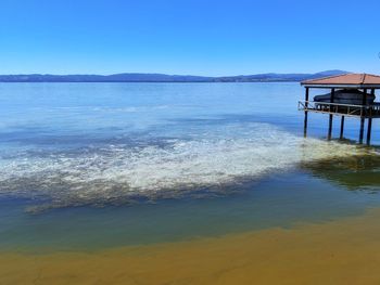 Scenic view of sea against clear blue sky