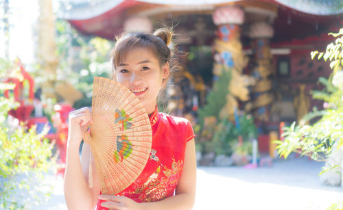 Portrait of smiling girl holding outdoors