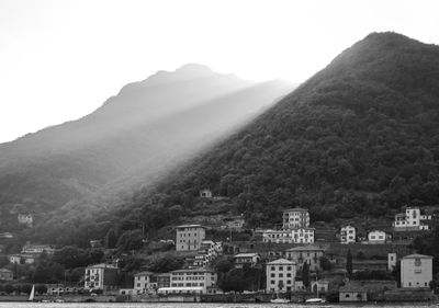 View of residential district against mountain range in foggy weather