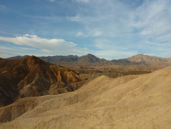 View of desert against cloudy sky