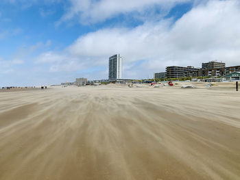 View of buildings in city against cloudy sky