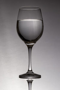 Close-up of wineglass against white background