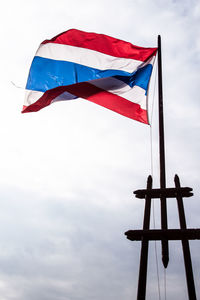 Low angle view of flag flags against sky