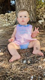 Portrait of cute girl sitting on hay