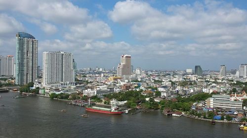 Cityscape against cloudy sky