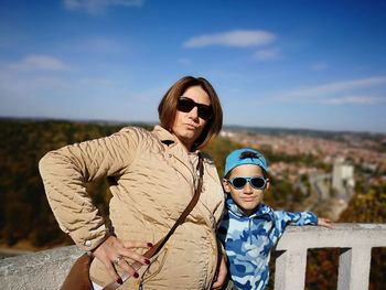 Portrait of mother with son standing at observation point