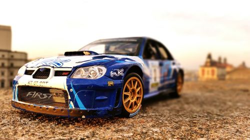 Close-up of toy car against blue sky