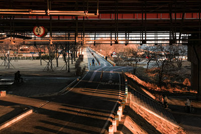 High angle view of people walking on railroad station