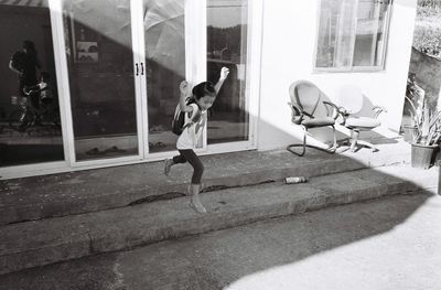 Full length of boy on window