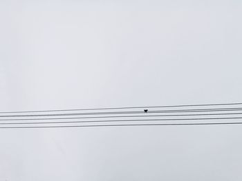 Low angle view of cables against clear sky