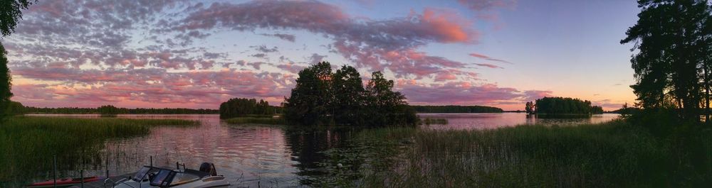 Scenic view of lake against sky at sunset