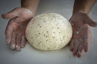 Man kneading a large dough for homemade bread in quarantine