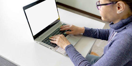 Low angle view of man using laptop on table