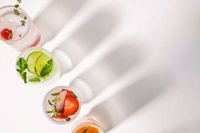 Infused waters with different flavors, summer refreshing drinks in a ribbed glasses, top view