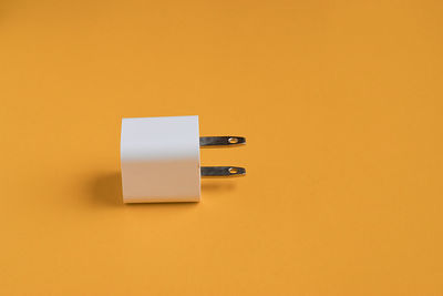 Close-up of pen on yellow wall