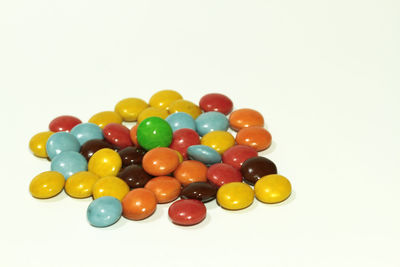 High angle view of multi colored balls on white background