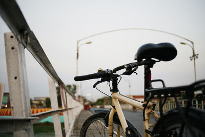 Close-up of bicycle on street against sky