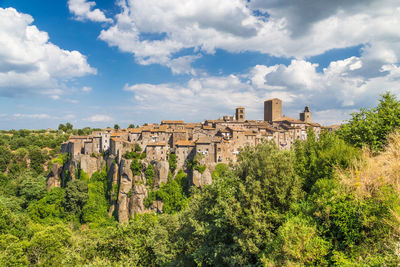 Low angle view of townscape against cloudy sky