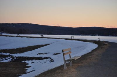 Scenic view of frozen lake against clear sky during winter