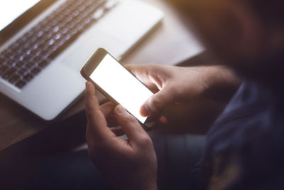 Midsection of man using mobile phone