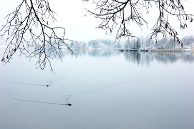 Scenic view of lake against sky during winter