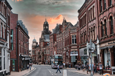 View of city street and buildings against sky