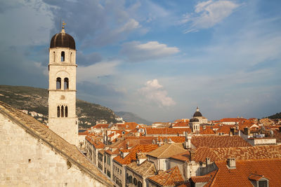 Buildings in town against sky