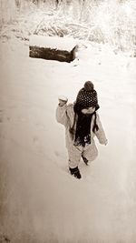 Woman standing on snow covered landscape