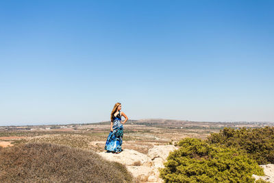 Woman with umbrella on land