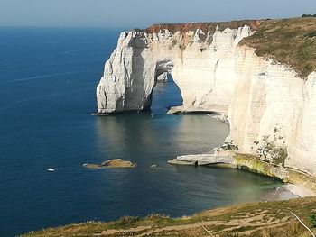 Scenic view of sea against rock formation