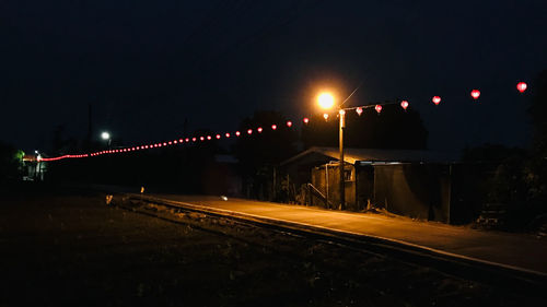 View of illuminated railroad tracks at night