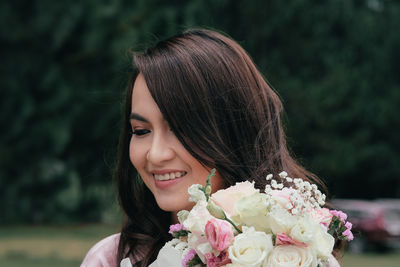 Portrait of woman with pink flower