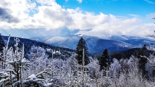 Scenic view of snow covered mountains against sky