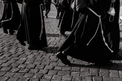 Low section of people walking on street