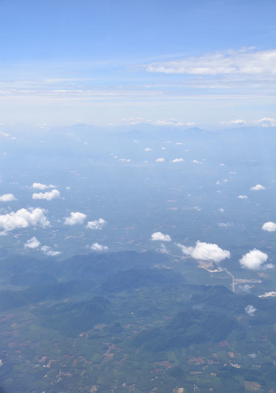 AERIAL VIEW OF CLOUDS OVER SEA AND MOUNTAIN